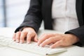 Hands of an office woman typing keyboard with credit card Royalty Free Stock Photo