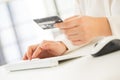 Hands of an office woman typing keyboard with credit card Royalty Free Stock Photo