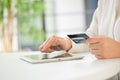 Hands of an office woman typing keyboard with credit card Royalty Free Stock Photo