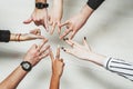 Hands of office workers in a circle. Different gestures of young people. Thumb up, peace sign and other signs