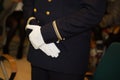 Hands of officer army in white gloves during official event