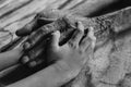 Hands of the old man and a child`s hand on the wood table. Black and white Royalty Free Stock Photo