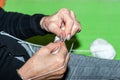 Hands of old woman crochets lace doily with needles selective focus close up Royalty Free Stock Photo