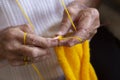 Hands of an old woman knitting needles