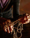 Hands of old woman with polyarthritis disease. Canvas strings on fingers of elderly lady, puppets