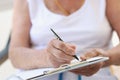 Hands of old woman with sheet for writing text Royalty Free Stock Photo