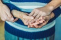 Hands of an old woman and a young man. Caring for the elderly. c Royalty Free Stock Photo