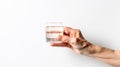 Hands of an older woman with glasses of clean drinking water, white background, copy space. Health and water balance