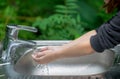 Hands open for drinking tap water. Pouring fresh healthy drink. Good habit. Right choice. Child washes his hand under the faucet