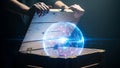 Hands open a wooden box revealing a glowing digital sphere with binary code inside it Royalty Free Stock Photo