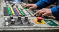 Hands operating industrial control panel with buttons switches and emergency stop control system machinery Royalty Free Stock Photo