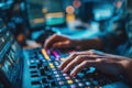 Hands operating a professional audio mixing console with colorful illuminated buttons in a dimly lit environment Royalty Free Stock Photo