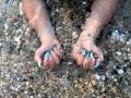 Hands with painted nails, in the sea.