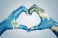 Hands, painted in the world map,  forming heart shape Royalty Free Stock Photo