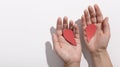 Hands with paper broken heart on white background Royalty Free Stock Photo