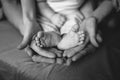 hands of parents concerned barefoot baby