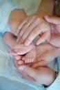 The hands of parents holding the feet of his son Royalty Free Stock Photo