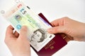 Hands, passport and currency Royalty Free Stock Photo