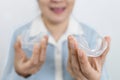 Hands of patient with sleep bruxism disease,asian female holding an occlusal splint to help care support her tooth while sleeping Royalty Free Stock Photo