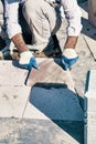 Hands of a pavement construction worker installing tiles Royalty Free Stock Photo