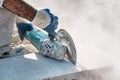 Hands of a pavement construction worker using an angle grinder for cutting the tiles Royalty Free Stock Photo