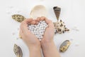 Hands with pearl beads and seashells Royalty Free Stock Photo