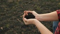 The hands of a peasant woman hold a handful of fertile soil with their bare hands, a view from above. The concept of Royalty Free Stock Photo