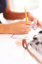 Hands, pencil and writing on letter on table, thought and communication for envelope in apartment. Young person, paper