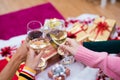 Hands of people celebrating New year party in home with wine drinking glasses. New year and Christmas party concept. Happiness Royalty Free Stock Photo