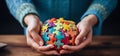 hands of people holding a colorful puzzle that is designed for autism Royalty Free Stock Photo