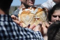 Hands of people touching decorated bread, celebration of Orthodox Easter