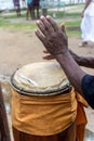 Hands of a percussionist playing atabaque at a religious event