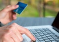 Hands of person entering credit Card Data on Laptop Royalty Free Stock Photo