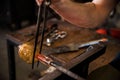 Hands of a person glass blowing in the workshop