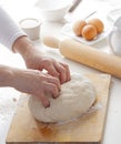 Hands of a person preparing pizza dough