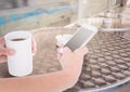 hands with phone and coffee in a terrace Royalty Free Stock Photo