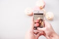 Hands photographing macarons