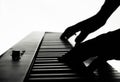 Hands of the pianist musician playing the piano keyboard at home