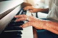 Hands, piano and senior man playing for music in living room for musical entertainment practice. Instrument, hobby and