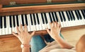 Hands, piano and senior woman playing for music in living room for musical entertainment practice. Instrument, hobby and