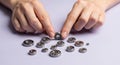 Hands Picking and Arranging Small Metal Bearings on White Surface for Mechanical Assembly Royalty Free Stock Photo