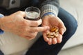 Hands with pills. Senior man hands holding medical pill and glass of water. Mature old senior grandfather taking Royalty Free Stock Photo