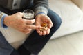 Hands with pills. Senior man hands holding medical pill and glass of water. Mature old senior grandfather taking Royalty Free Stock Photo