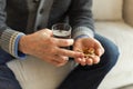 Hands with pills. Senior man hands holding medical pill and glass of water. Mature old senior grandfather taking Royalty Free Stock Photo