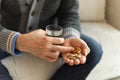 Hands with pills. Senior man hands holding medical pill and glass of water. Mature old senior grandfather taking Royalty Free Stock Photo