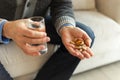 Hands with pills. Senior man hands holding medical pill and glass of water. Mature old senior grandfather taking Royalty Free Stock Photo