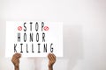 Hands with Placard showing the Stop Honor Killing on isolated background