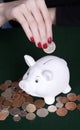 Hands placing a coin into a moneybag