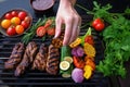 hands placing vegetables beside grilled seitan steak