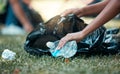 Hands, plastic bottle and recycling volunteer woman cleaning up garbage and environment trash park problem